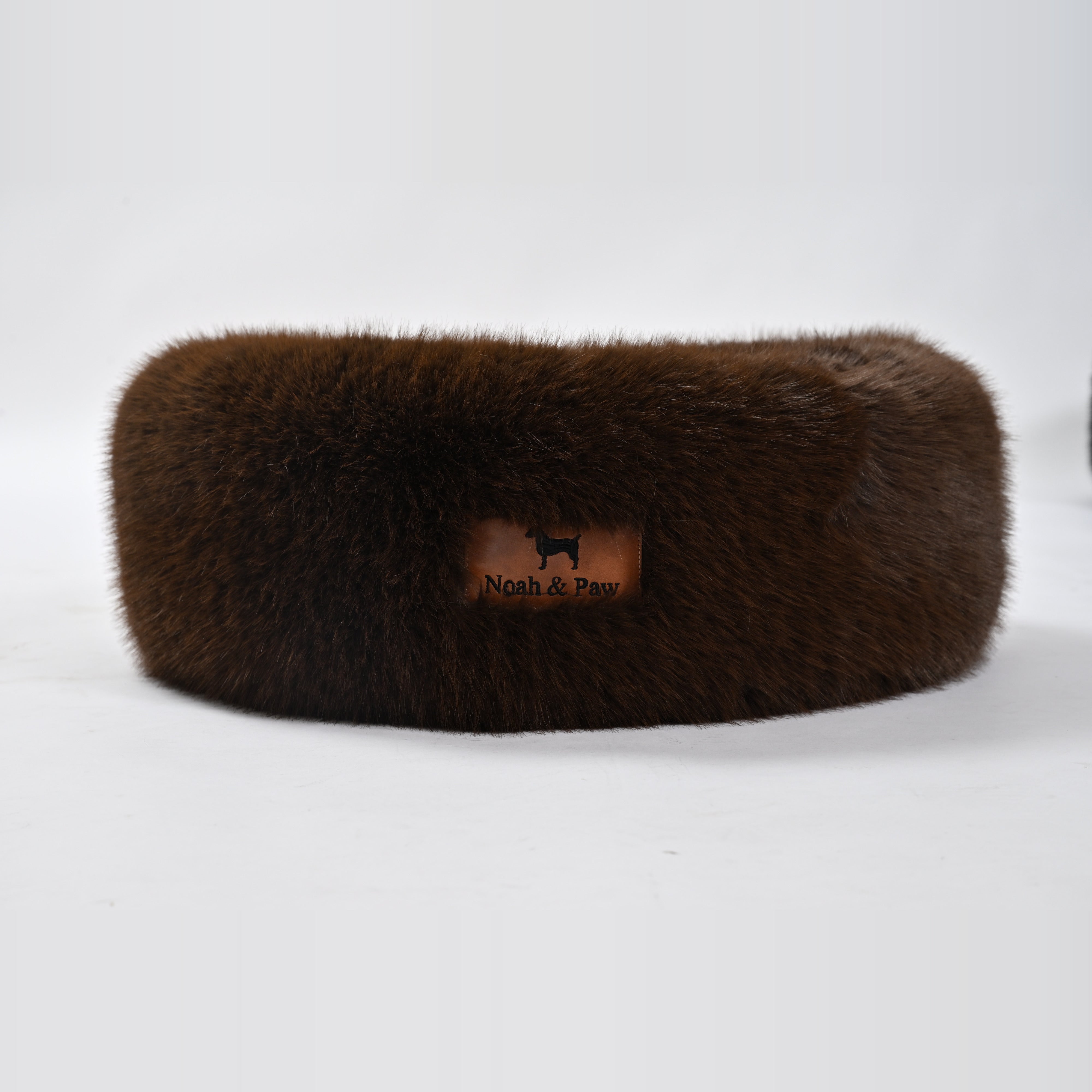 Brown donut dog bed side view