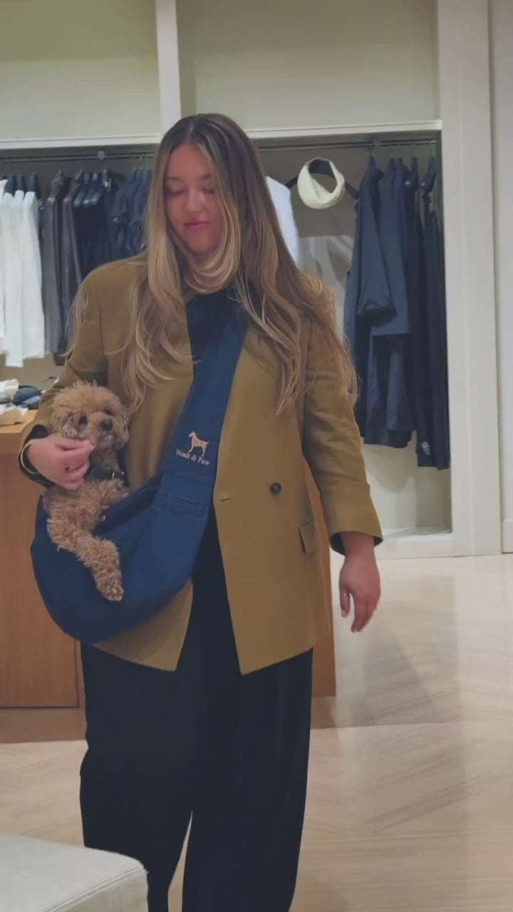 Video: hands-free carry in the Noah & Paw dark blue denim snap style dog sling carrier
